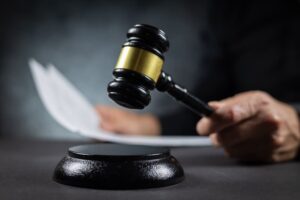Judge with paper document pronouncing sentence in a court of law.