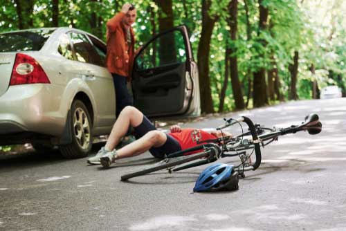 A man that struck by a car while riding a bicycle. 
