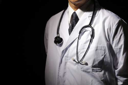 A doctor in his white coat.