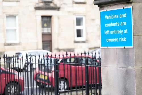 A premises liability statement on a blue sign.