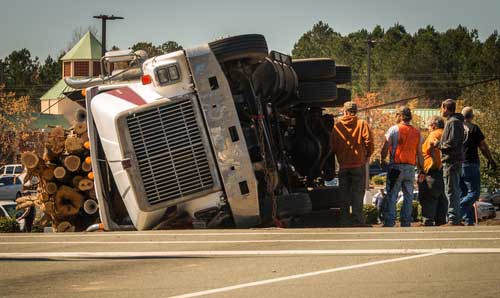 A truck that has rolled over on it's side.