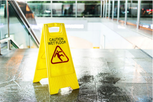 Wet floor sign, concept of Atlanta slip and fall attorney