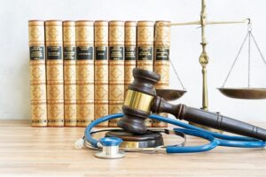 Medical malpractice lawyer concept, stethoscope with law symbols