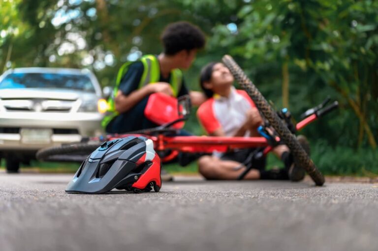 A bicyclist injured on the road after hit by a car