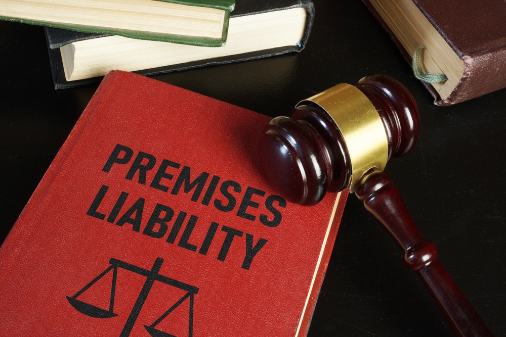 Premises liability law book and judge’s gavel symbolizing legal action for unsafe property injuries in Albany.