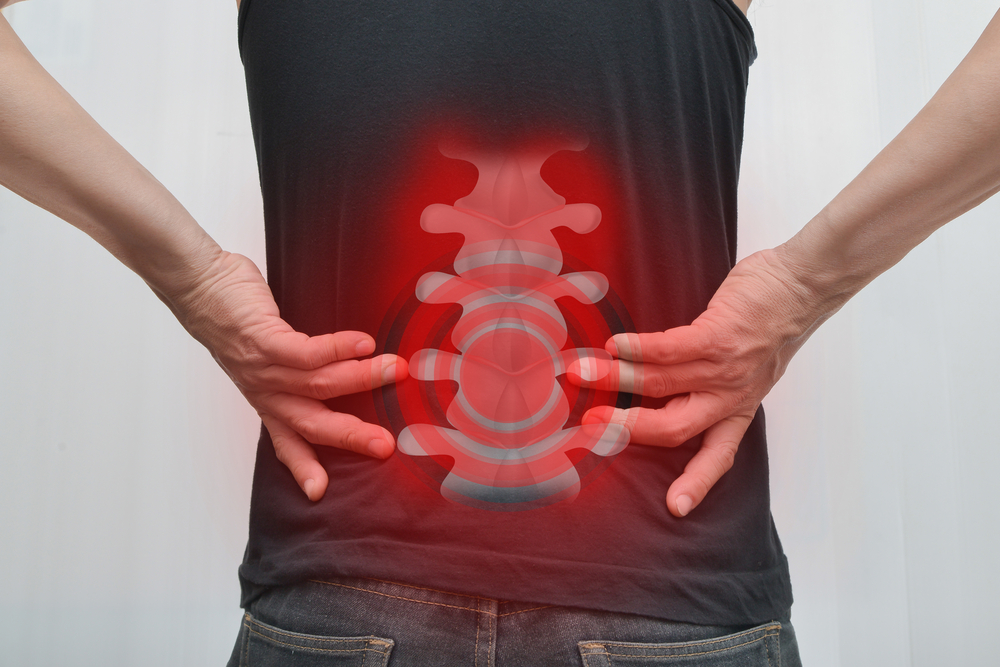 Person experiencing severe lower back pain related to spinal cord injury