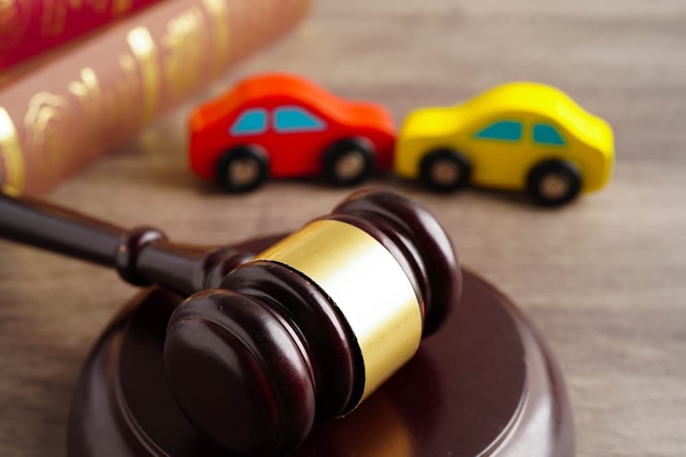 Judge's Gavel and toy cars in background - Concept of Car insurance claim