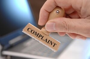 complaint marked on rubber stamp in hand