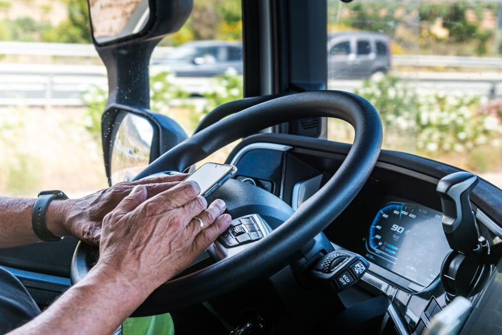 Commercial truck driver texting while driving on a Georgia highway