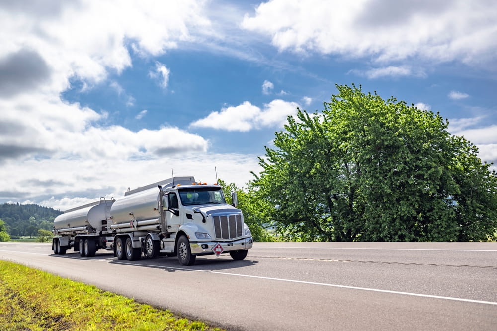 Large commercial tanker truck driving on a rural Georgia highway