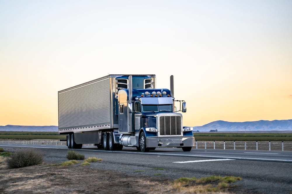 Semi-truck traveling on a Georgia interstate highway at sunset