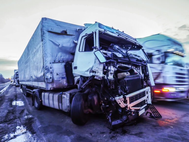 Severely damaged semi-truck after a front-end commercial truck collision.