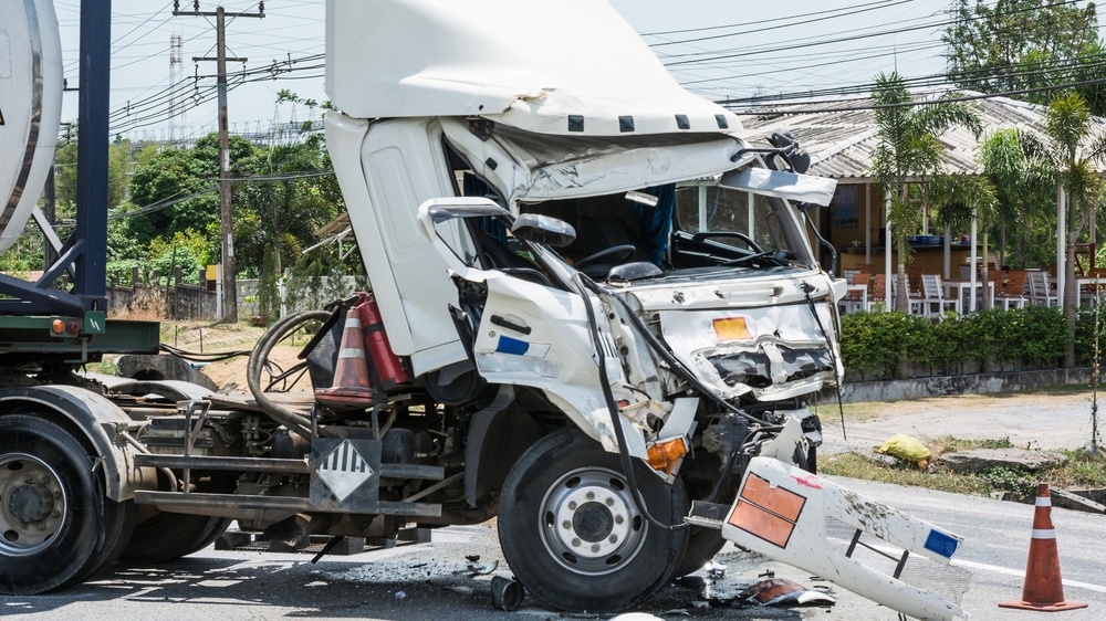 Severely damaged semi-truck after a crash caused by truck driver negligence.