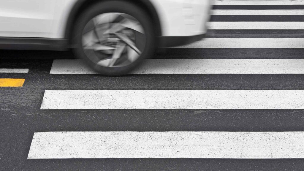 A speeding car drives over a crosswalk where a Savannah Pedestrian Accident Lawyer helps injured victims.